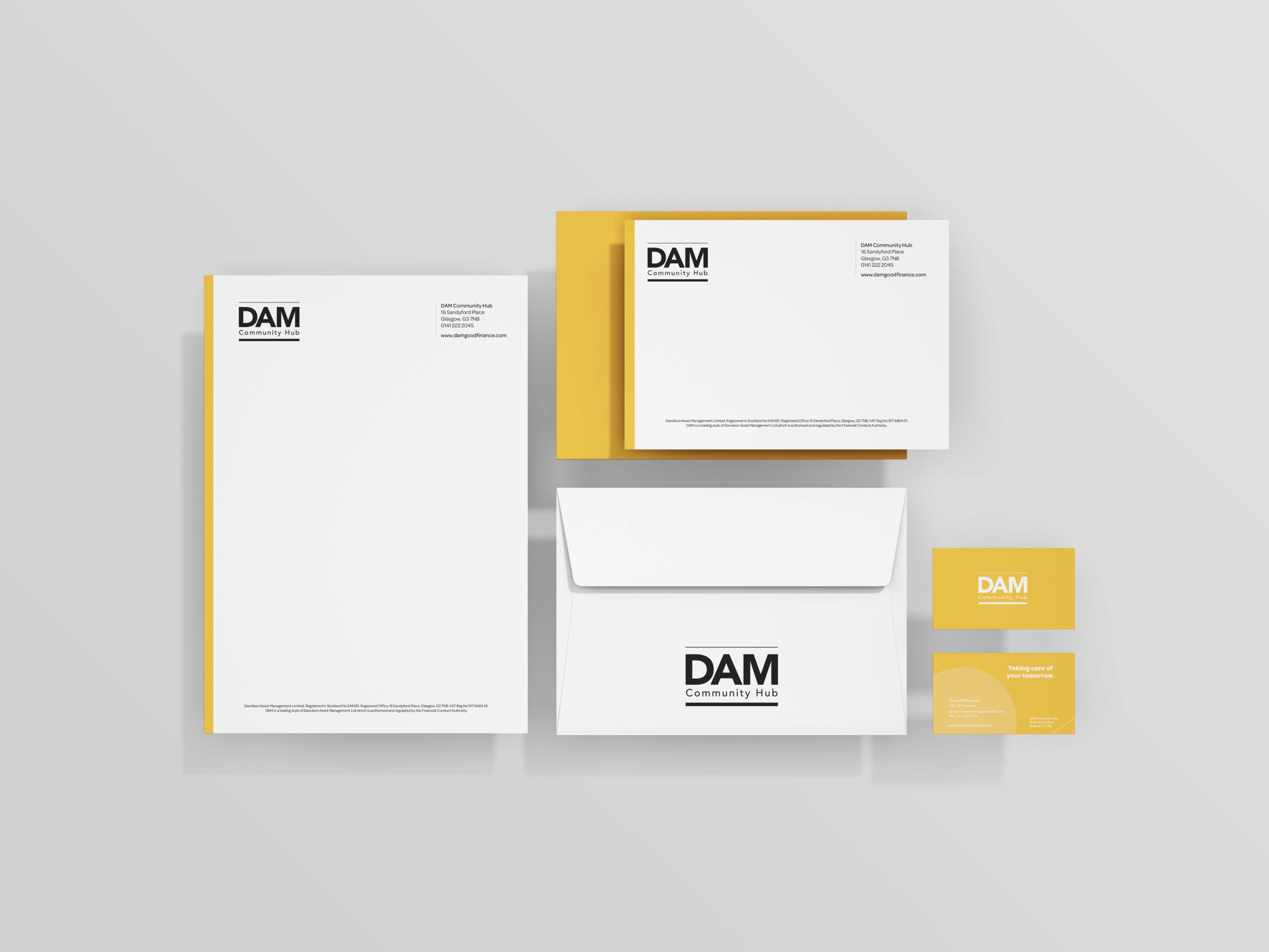 DAM brand identity applied to letterhead, envelope and business cards